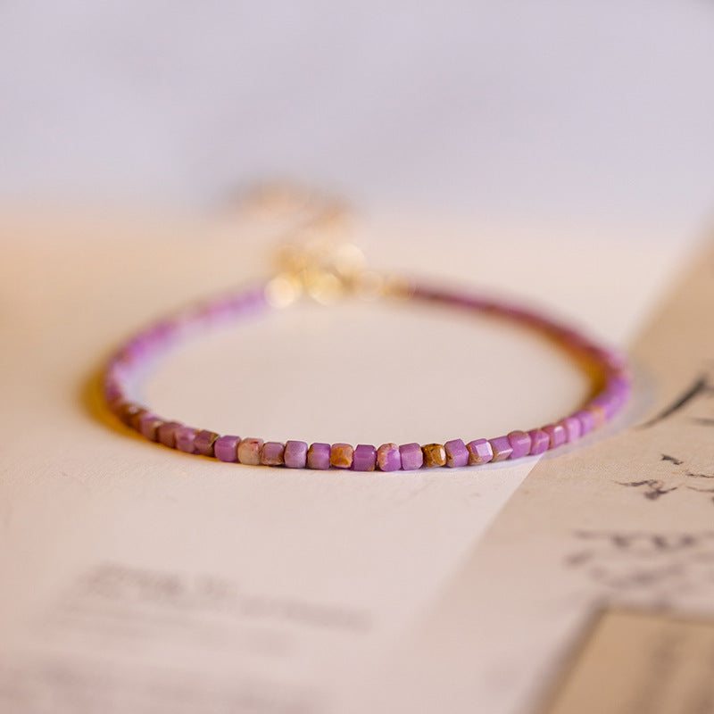 Minimalist purple crystal bracelet on oriental wood