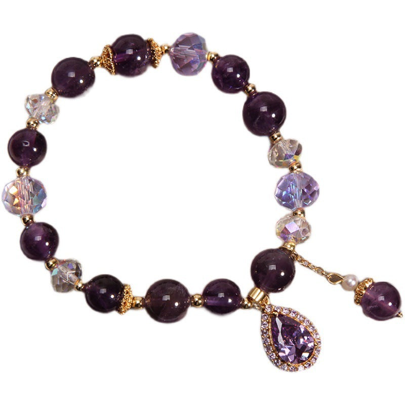 Amethyst beaded bracelet with pear-shaped cubic zirconia pendant on white background
