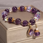 Close-up of Amethyst beads and sparkling faceted crystals on a bracelet