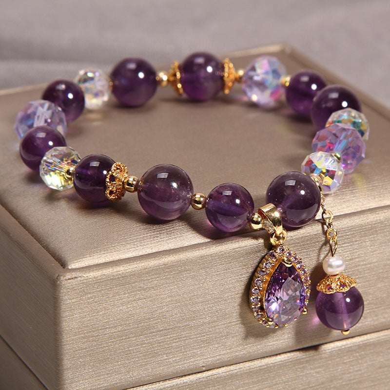 Close-up of Amethyst beads and sparkling faceted crystals on a bracelet