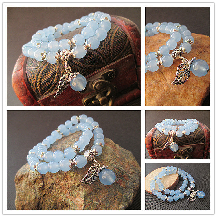 Blue Chalcedony beaded double-wrap bracelet with silver charms on display