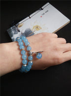 Blue Chalcedony beaded double-wrap bracelet with silver charms on wrist