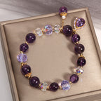 Elegant Amethyst crystal bracelet with sparkling charms on a golden display
