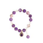 Overhead view of Amethyst and dazzling charm bracelet on a display
