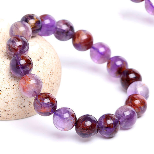 Spiritual practitioner meditating with high vibration Super Seven bracelet