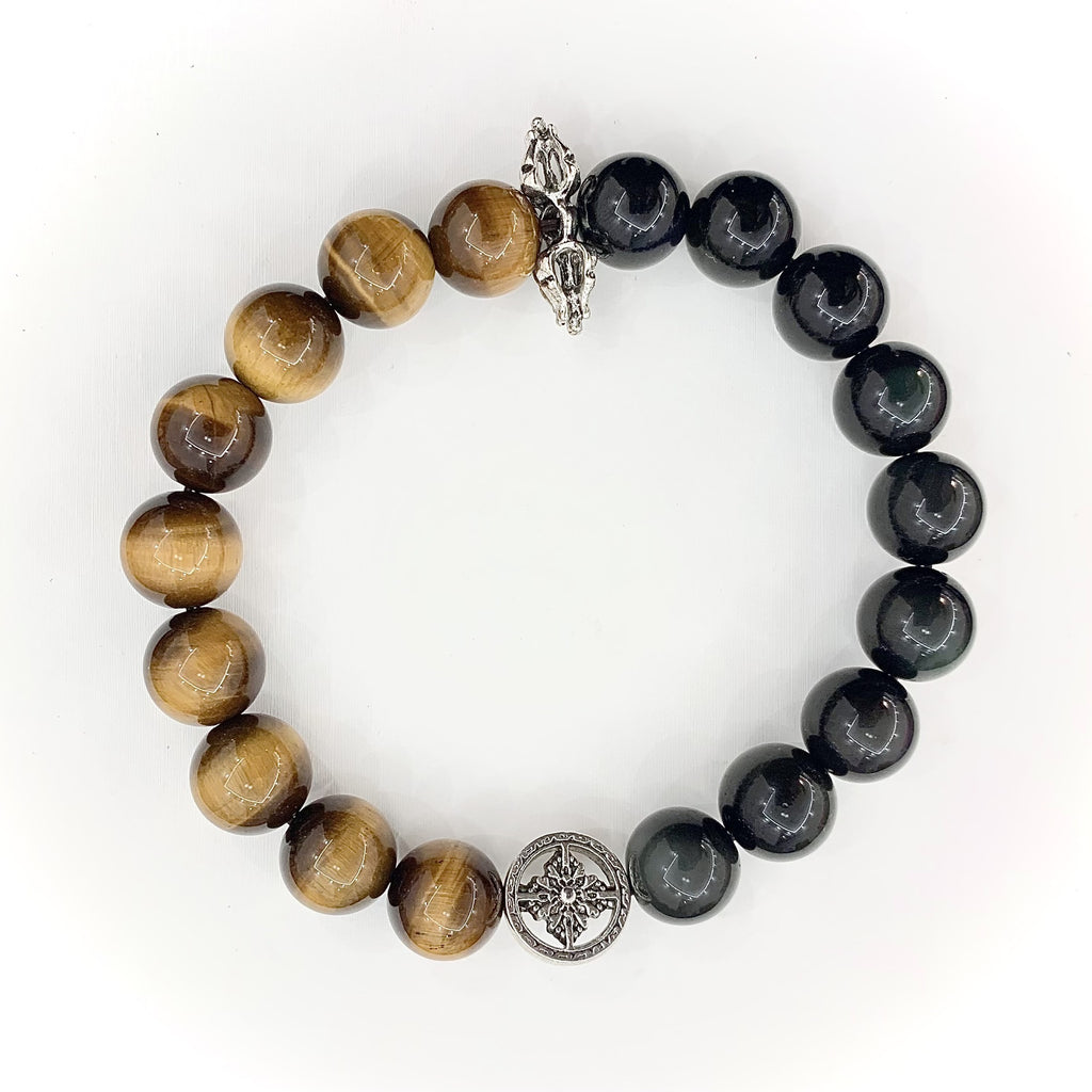 Tiger's Eye and Obsidian bracelet on a wrist with silver charm detail