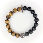 Tiger's Eye and Obsidian bracelet on a wrist with silver charm detail